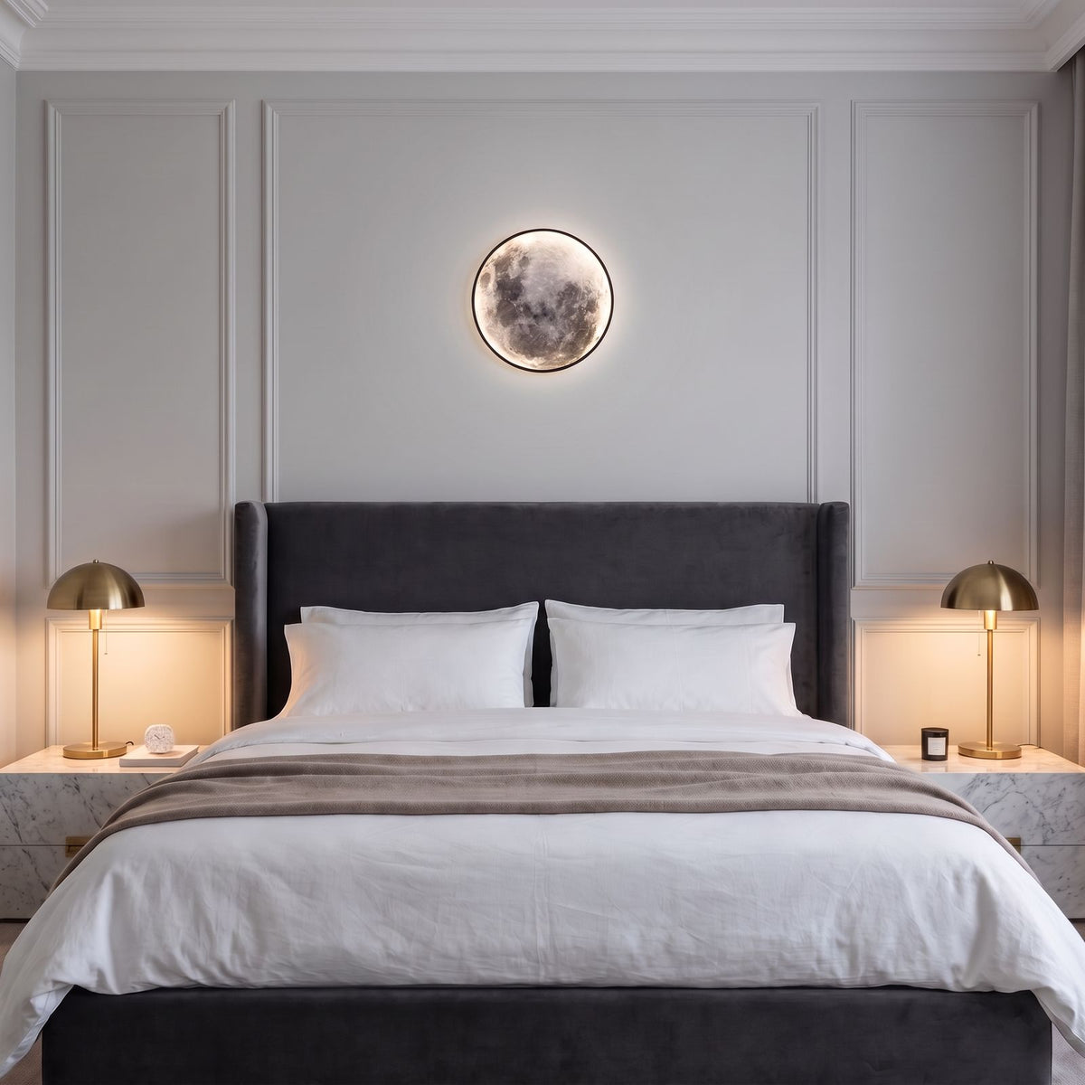 Round 3D Moon Black Frame LED Wall Light centred above a velvet bedhead in a luxury panelled master bedroom
