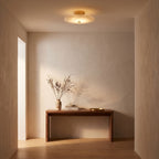 Round Alabaster Flush Wall and Ceiling Light in a hallway above a timber console