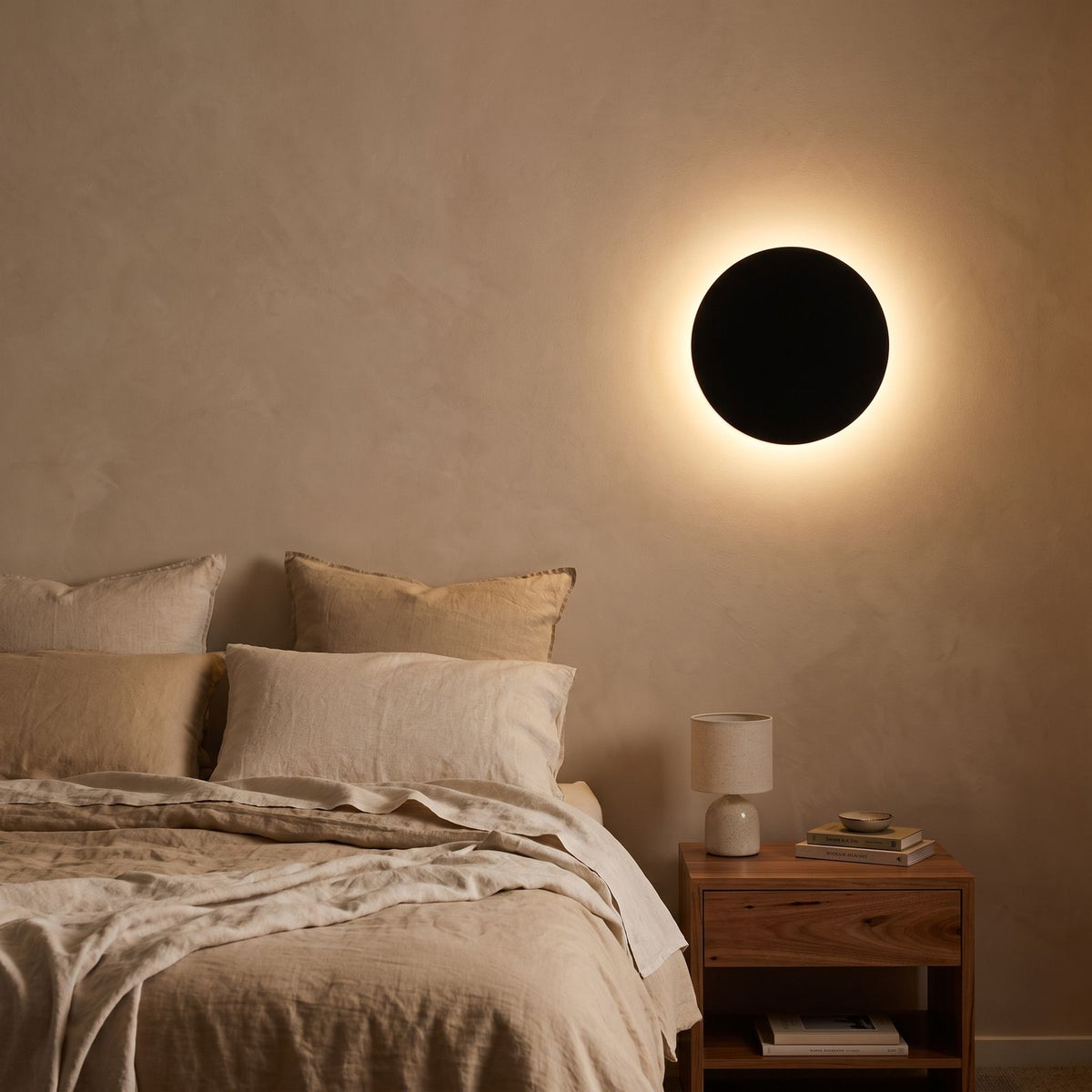 Round Aluminium Disc LED Wall Light beside a bed