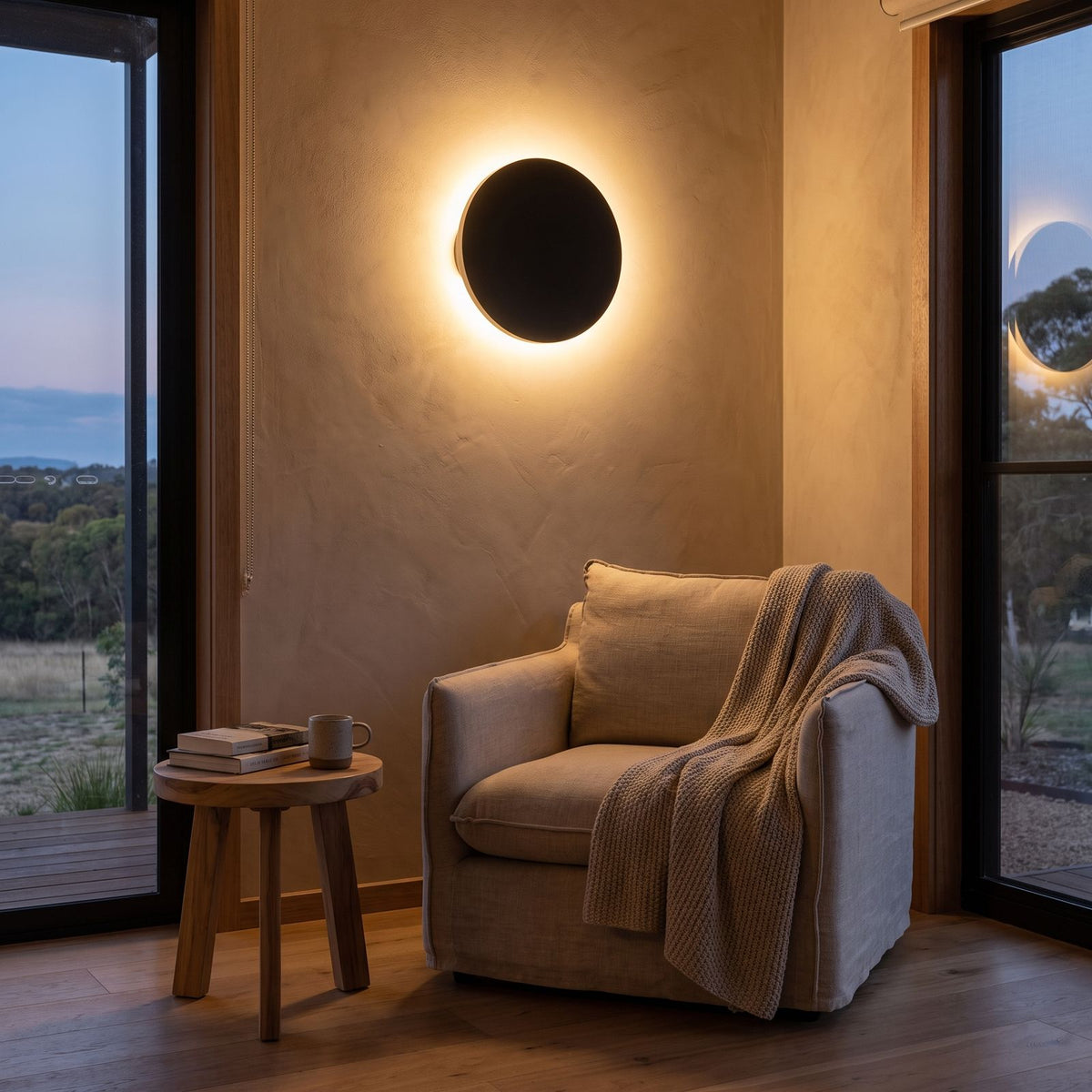 Round Aluminium Disc LED Wall Light above an armchair in a reading corner
