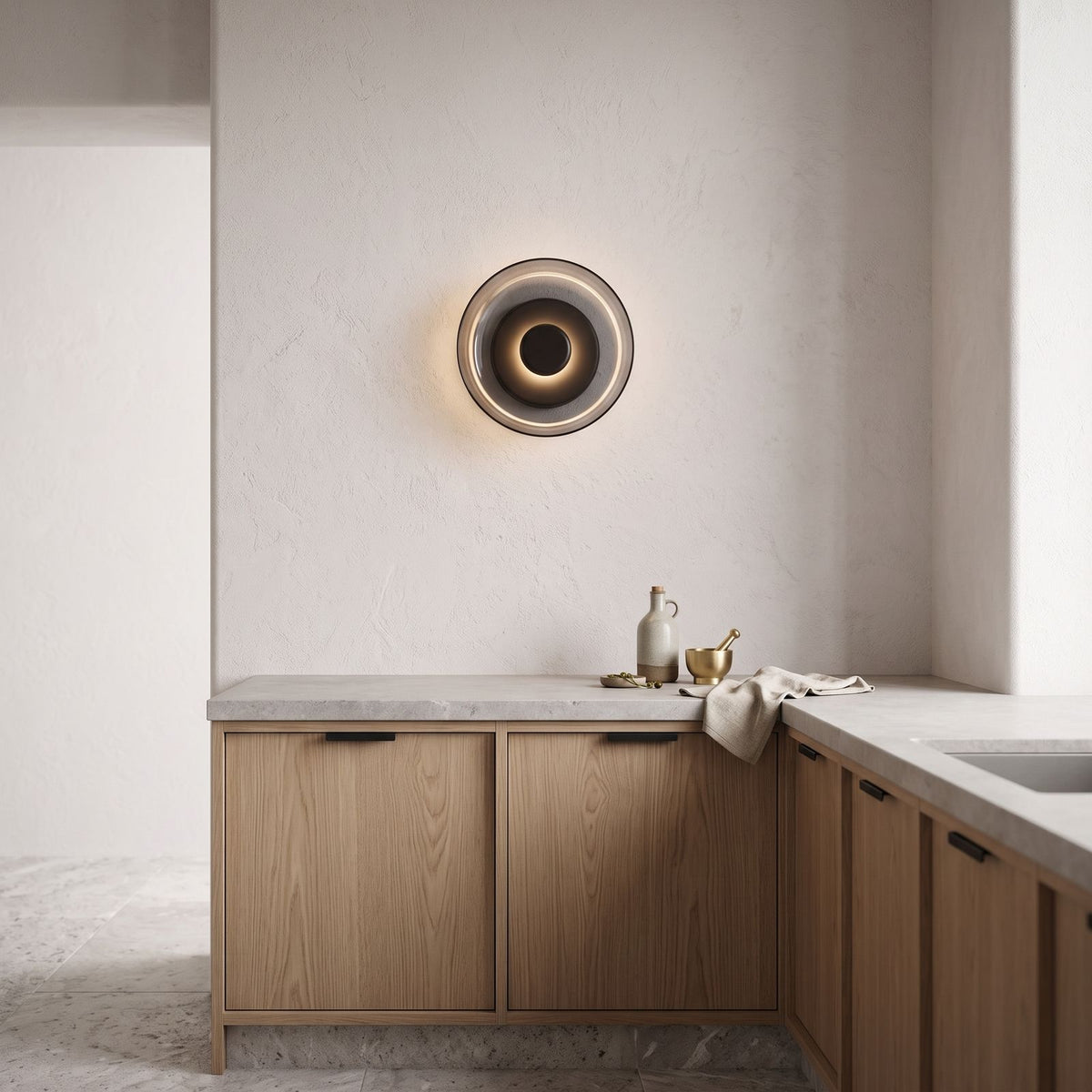 Round Glass Dish LED Wall Light on a kitchen wall