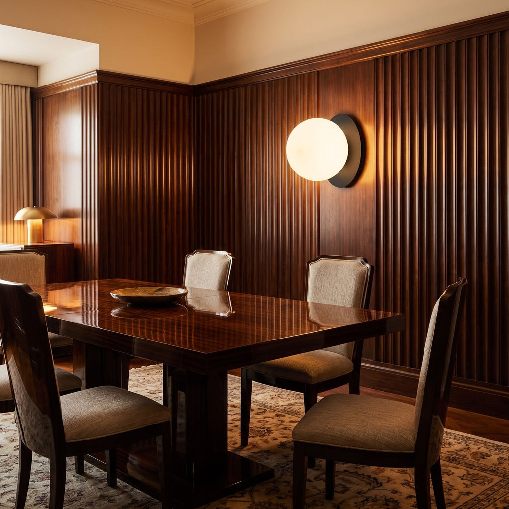 Round Glass Wall Sconce with Metal Backplate on a dining room wall