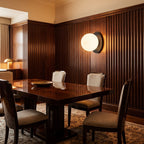 Round Glass Wall Sconce with Metal Backplate on a dining room wall