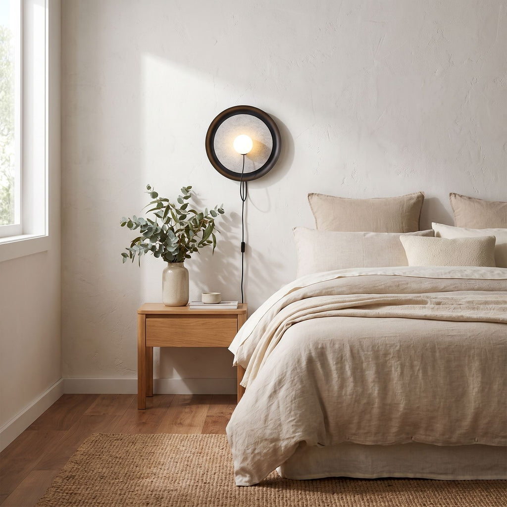 Round Iron Ring Wall Light with Magnetic Bulb on a bedroom wall beside the bed