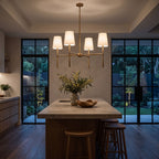 Round Metal Arm Tapered Shade Chandelier above a kitchen island at night