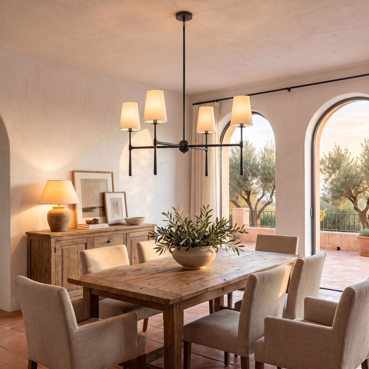 Round Metal Arm Tapered Shade Chandelier in black above a dining table at golden hour