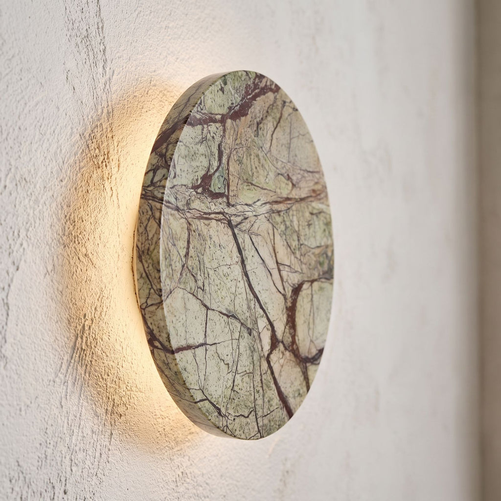 Round Natural Marble LED Wall Light, close view at 45 degrees on a plaster wall