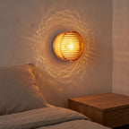 Round Ribbed Glass LED Wall Light beside a bed