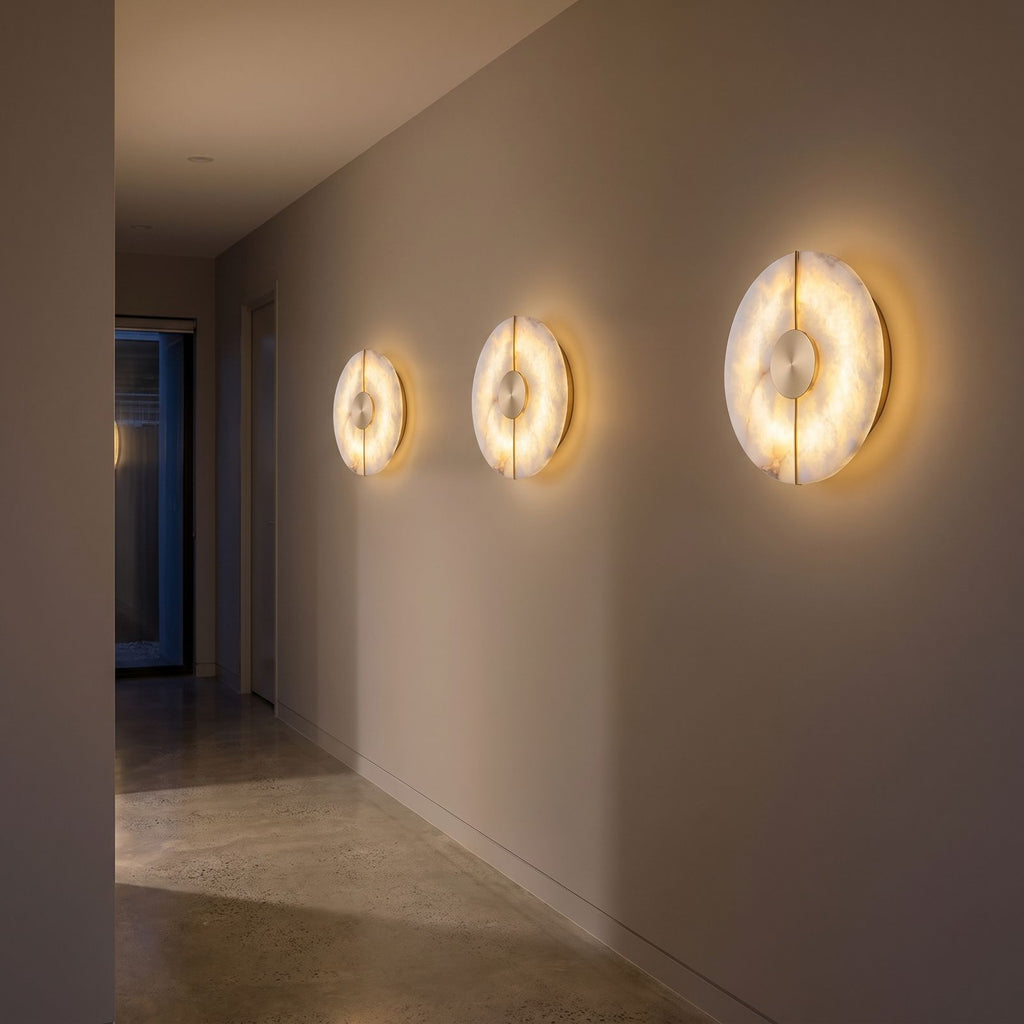 Round Split Marble Disc LED Wall Light three in a row along a hallway at night