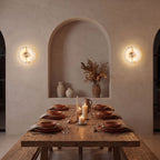 Round Split Marble Disc LED Wall Light pair either side of an arched niche in a dining room at night