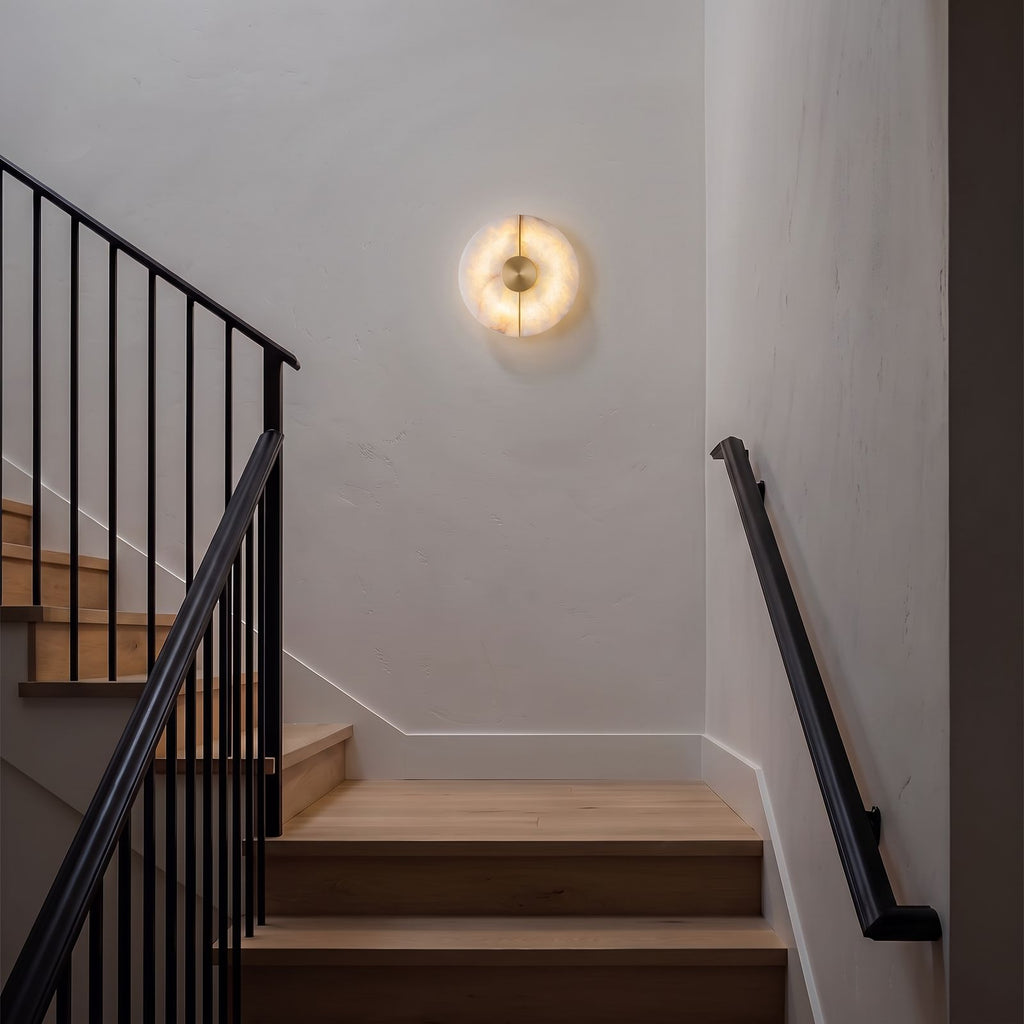 Round Split Marble Disc LED Wall Light on a staircase wall in a modern farmhouse at night