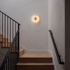 Round Split Marble Disc LED Wall Light on a staircase wall in a modern farmhouse at night