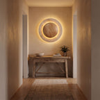 Round Travertine and Wood Shade LED Wall Light in a hallway above a timber console