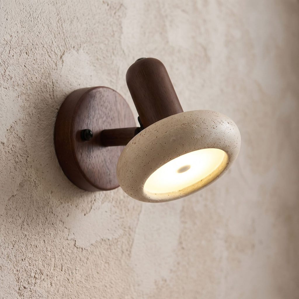 Round Travertine Swivel Bedside Wall Light, close view at 45 degrees on a plaster wall