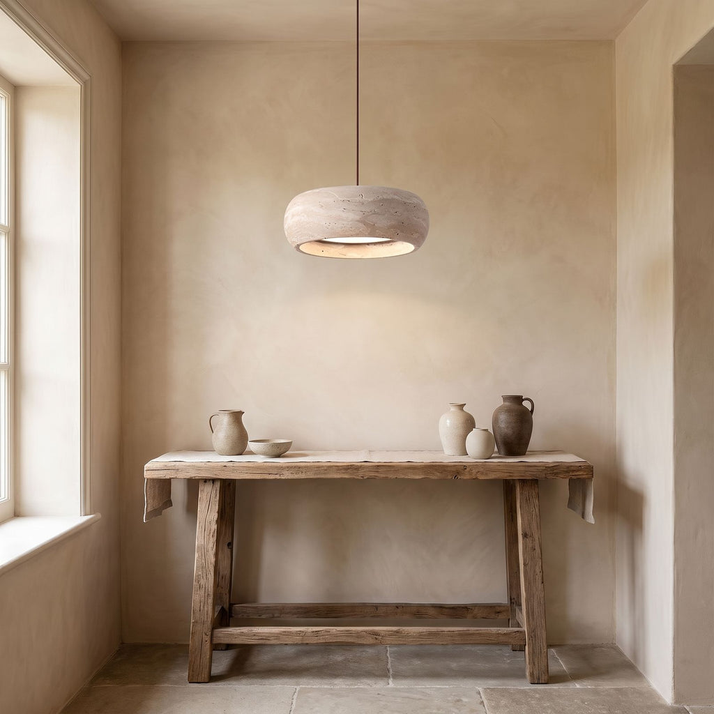 Rounded Travertine Puck LED Pendant Light above a console in an entry hallway