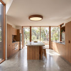 Wood grain LED oyster ceiling light on a hallway ceiling