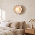 Ruffled Ceramic Flower Wall Light beside a bed