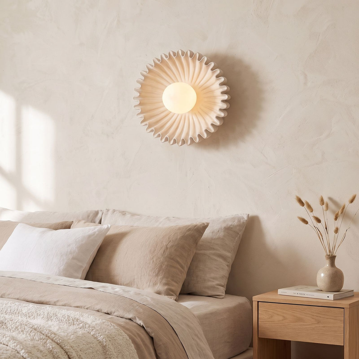 Ruffled Ceramic Flower Wall Light beside a bed