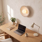 Ruffled ceramic flower wall light above a home office desk in daylight