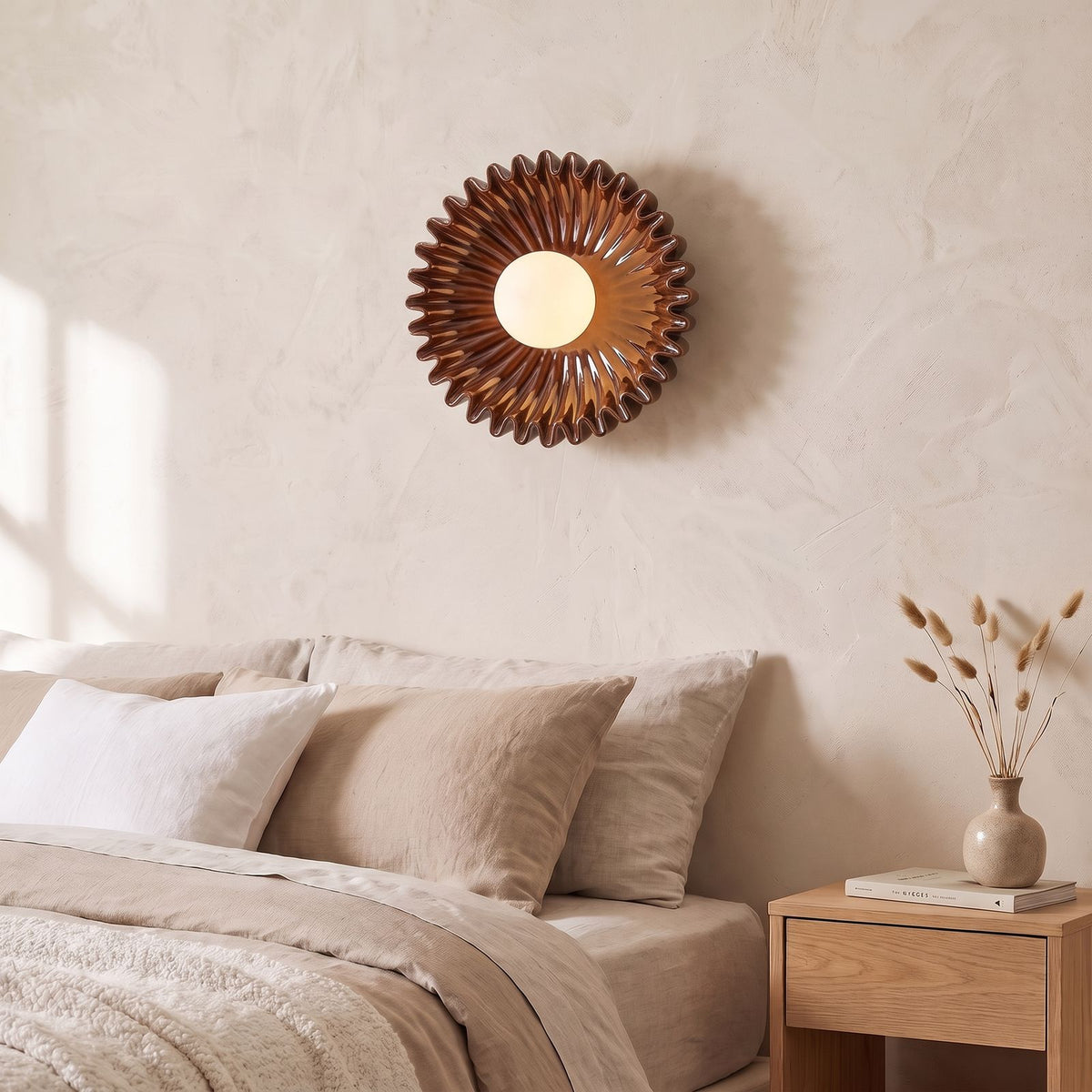 Ruffled Ceramic Flower Wall Light in brown beside a bed
