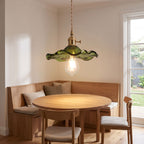 Ruffled fluted glass pendant light over a breakfast nook table