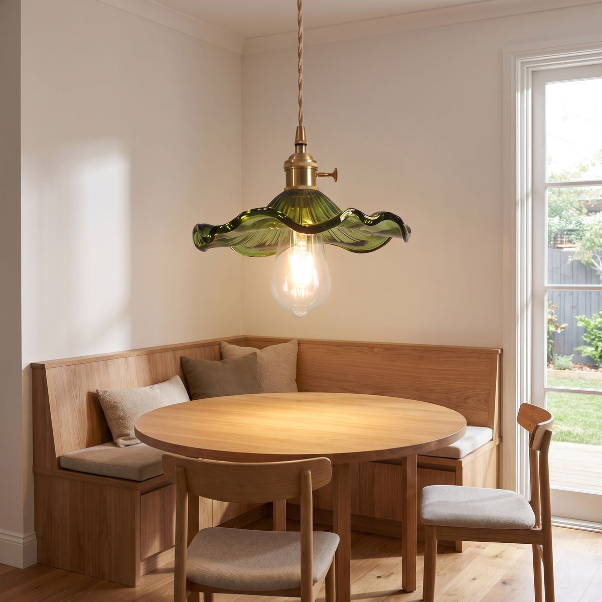 Ruffled fluted glass pendant light over a breakfast nook table