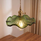 Close-up of the fluted green glass rim and brass-tone lamp holder