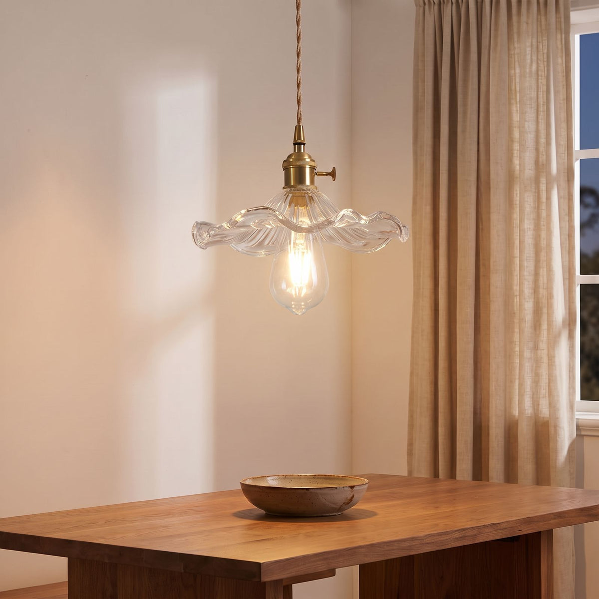 Ruffled Fluted Glass Flower Pendant Light in clear glass above a dining table