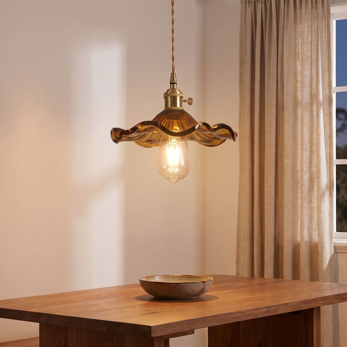 Ruffled Fluted Glass Flower Pendant Light in amber brown glass above a dining table