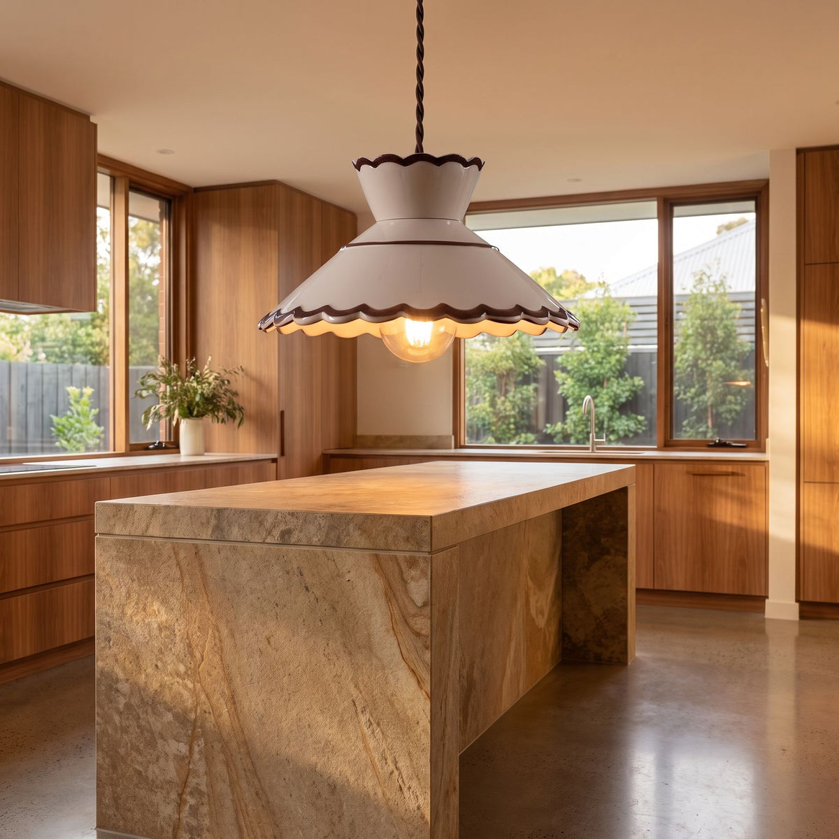 Scalloped cream ceramic pendant light over a kitchen island bench