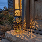 Scroll pattern metal solar lantern on a front door step