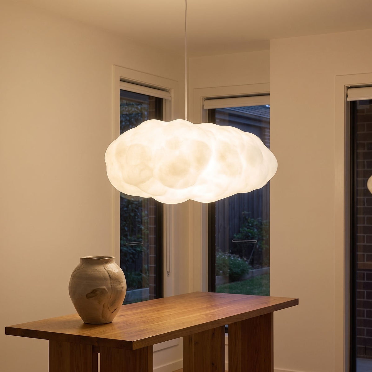 White cloud pendant light above an entry hall console