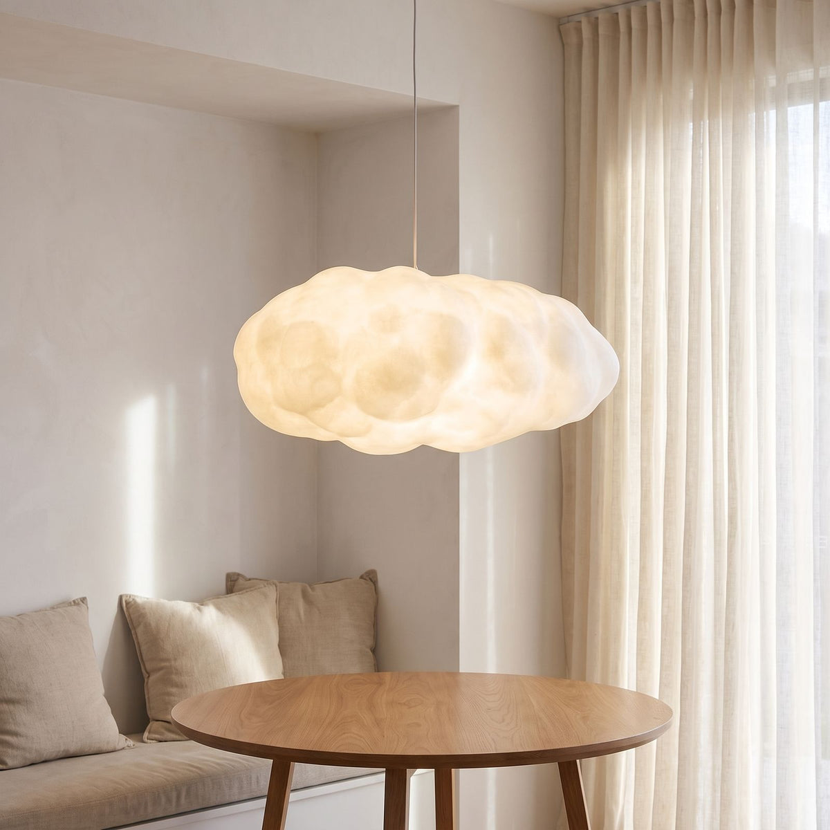 White cloud pendant light over a breakfast nook table