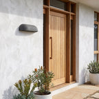 Semi Oval Stone Outdoor Wall Light beside a timber front door