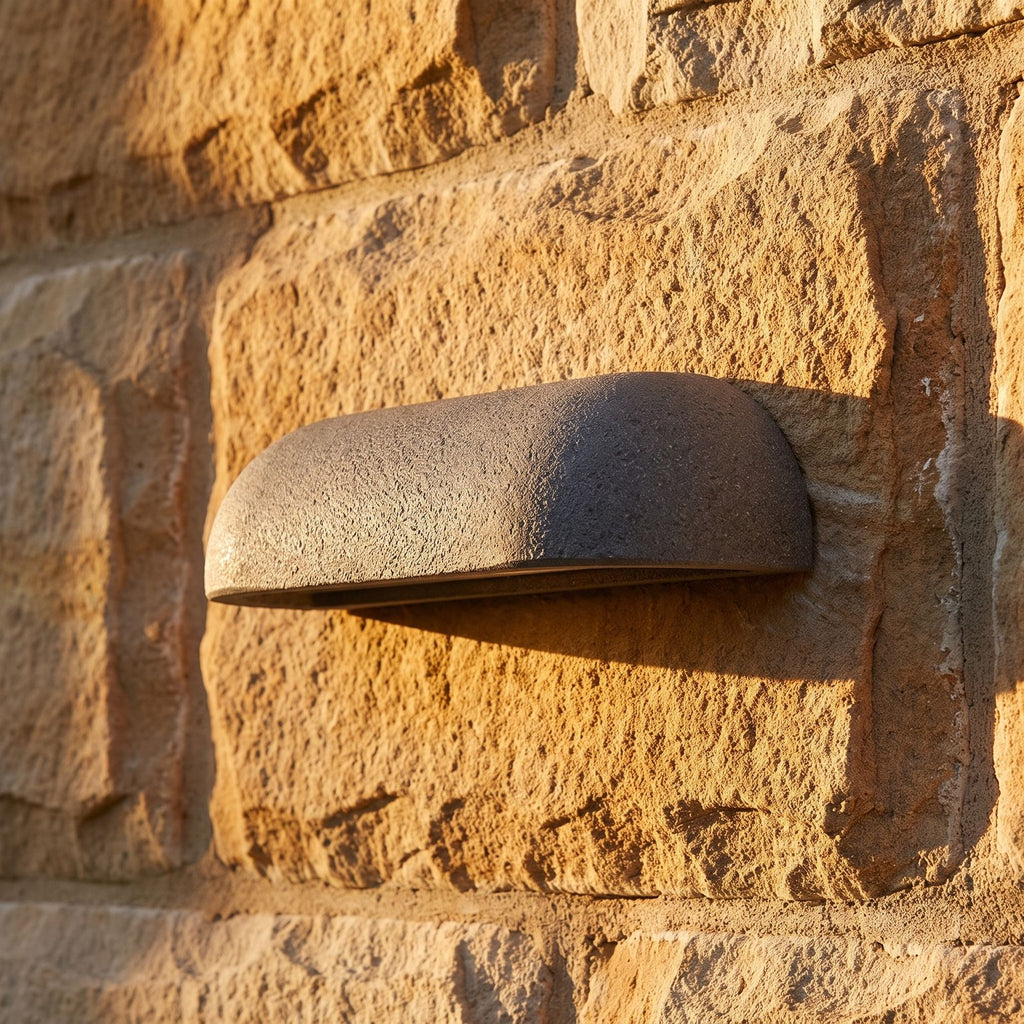 Semi Oval Stone Outdoor Wall Light, close view at 45 degrees on a stone wall