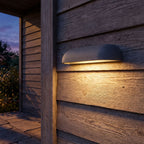 Semi Oval Stone Outdoor Wall Light on a porch wall at dusk