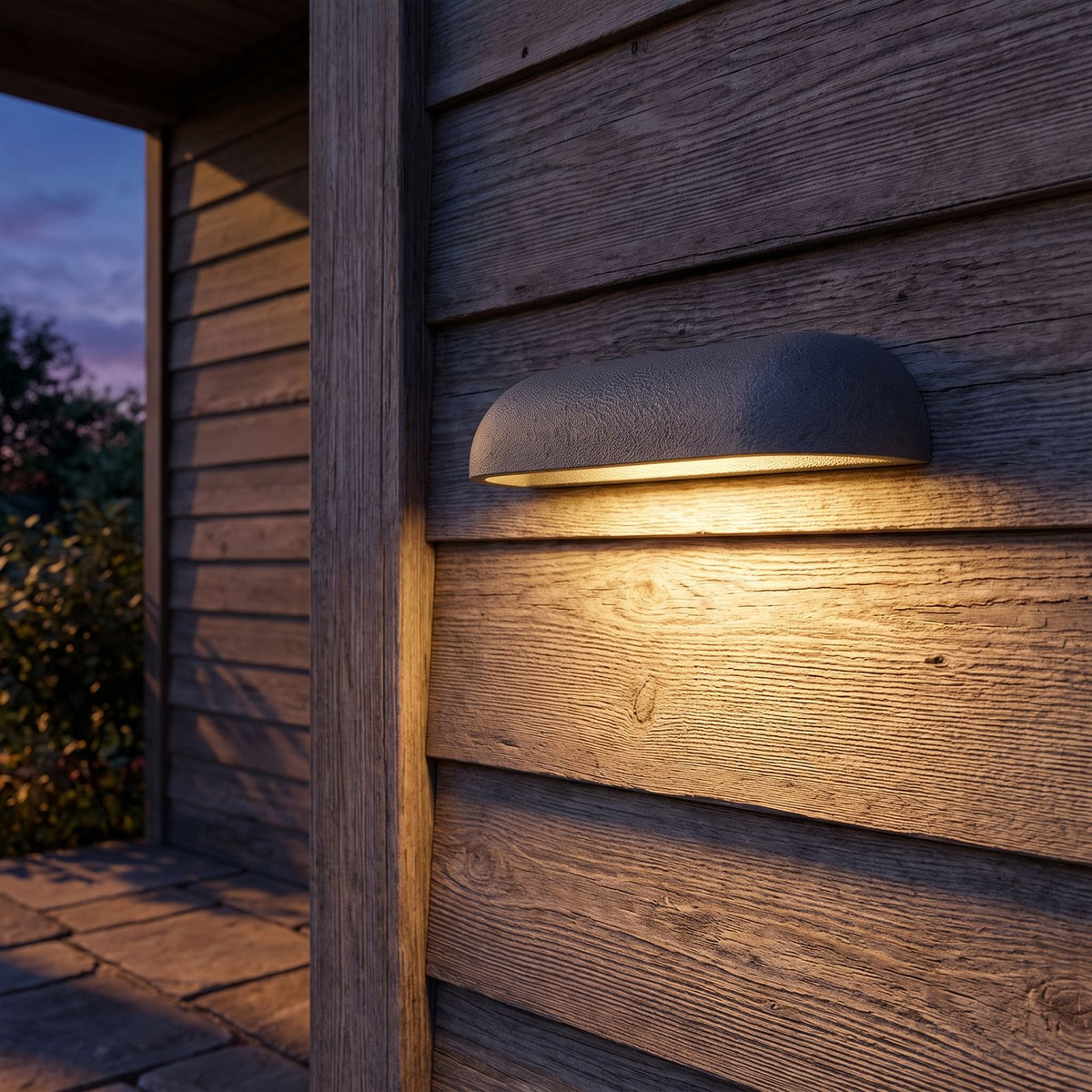 Semi Oval Stone Outdoor Wall Light on a porch wall at dusk