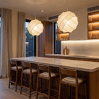 A pair of Silk Ball Japandi LED Pendant Lights over a stone kitchen island