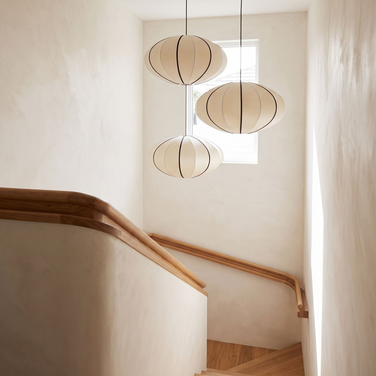 Silk Pumpkin Lantern Japandi Pendant Light in a group of three in a stairwell