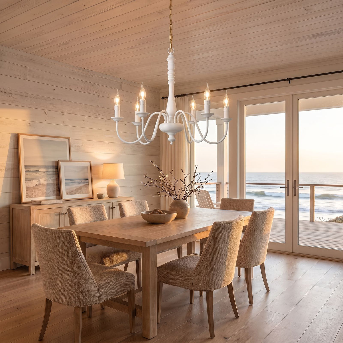 Six Arm Distressed Candle Chandelier in white above a dining table at golden hour