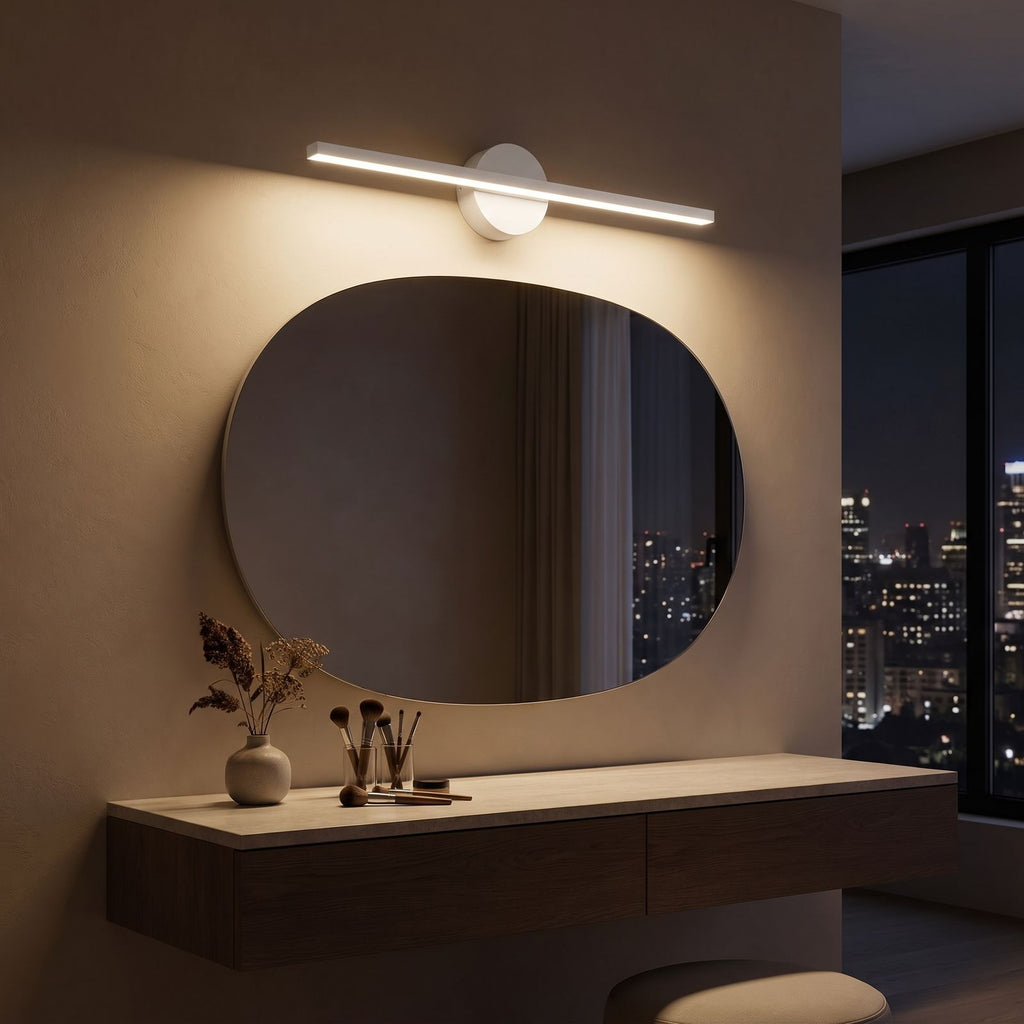 Slim Aluminium Disc and Bar LED Vanity Wall Light above the mirror of a makeup table at night