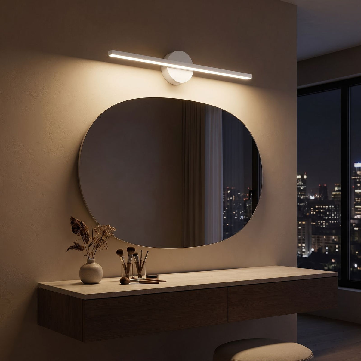 Slim Aluminium Disc and Bar LED Vanity Wall Light above the mirror of a makeup table at night