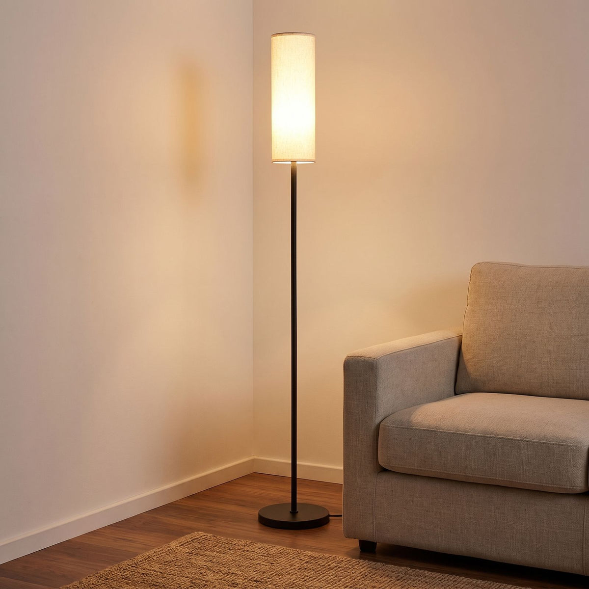 Slim Black Fabric Cylinder Shade Floor Lamp beside an armchair in a living room corner