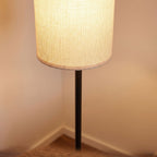 Close-up of the woven fabric cylinder shade on the black pole