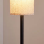 Close-up of the cream linen cylinder shade and matte black pole