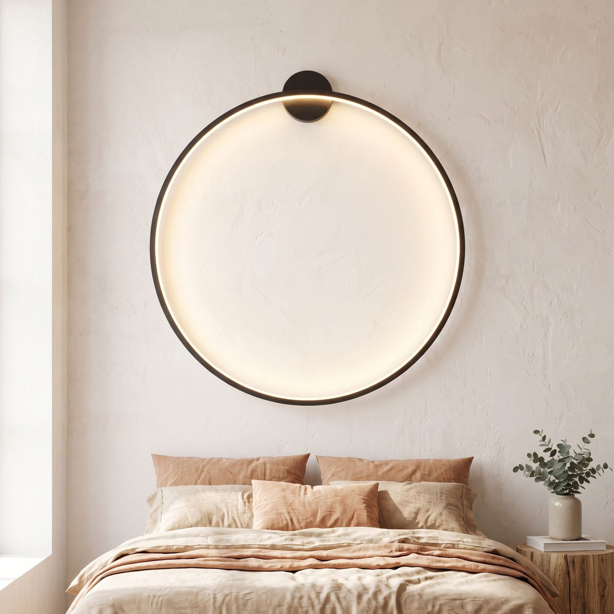 Slim Black Ring Backlit LED Wall Light above a bed