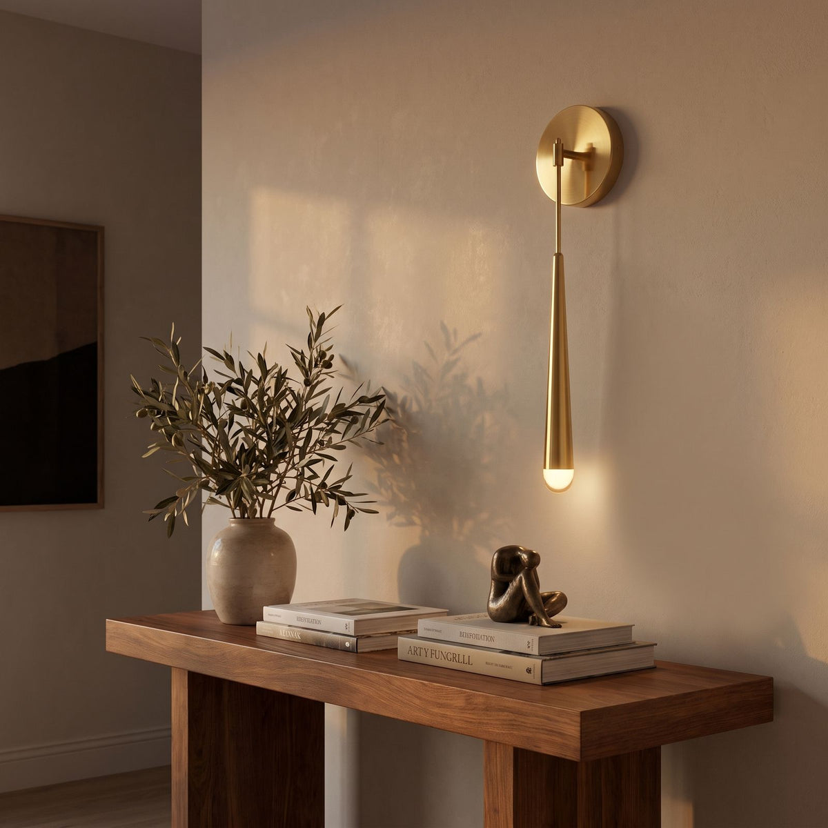 Slim Brass Teardrop Wall Sconce in a hallway above a timber console