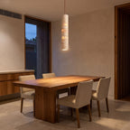 Slim Cream Marble Tube LED Pendant Light above a timber dining table