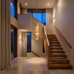 Slim Cream Marble Tube LED Pendant Light in a double-height entry foyer