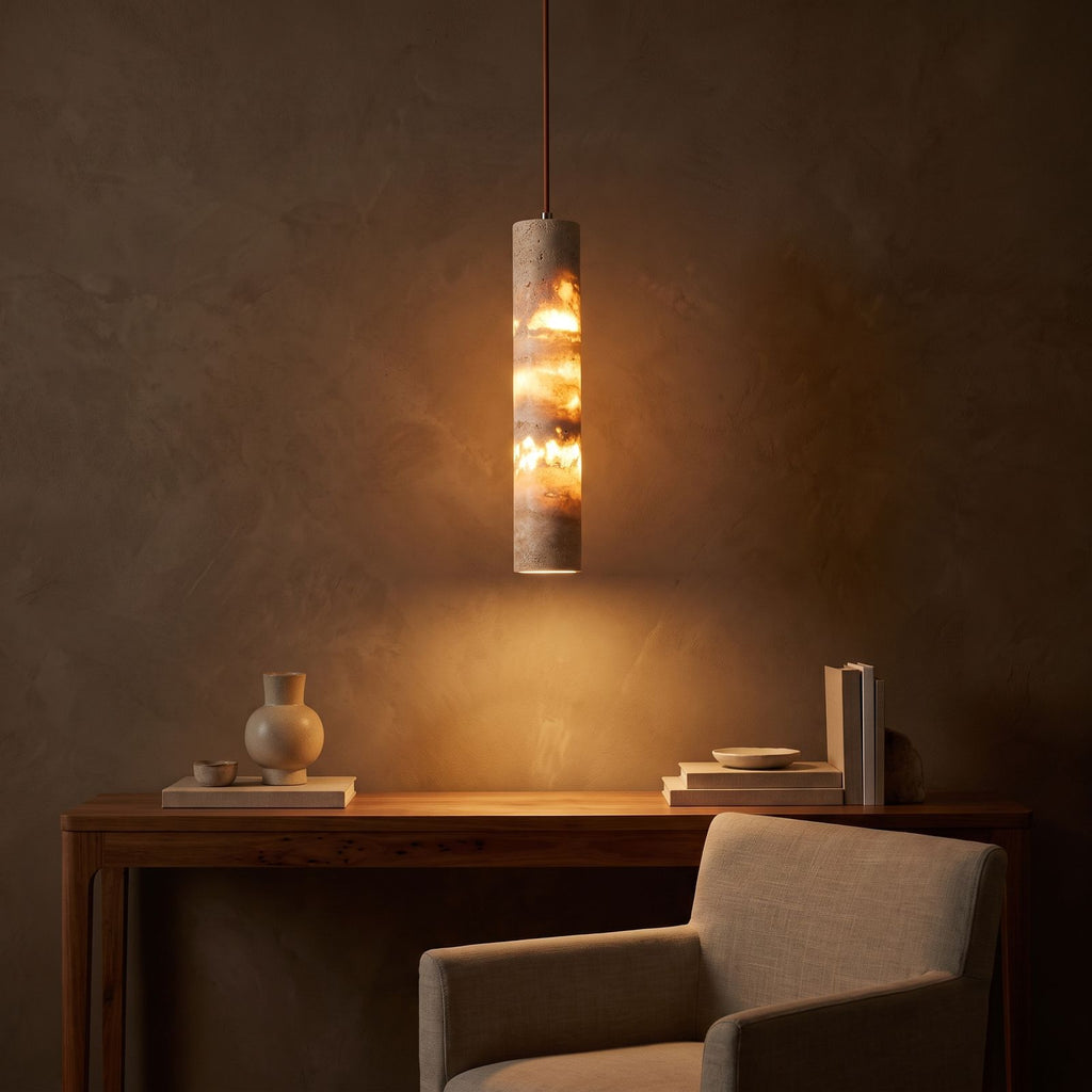 Slim Cream Marble Tube LED Pendant Light glowing against a plaster wall at night